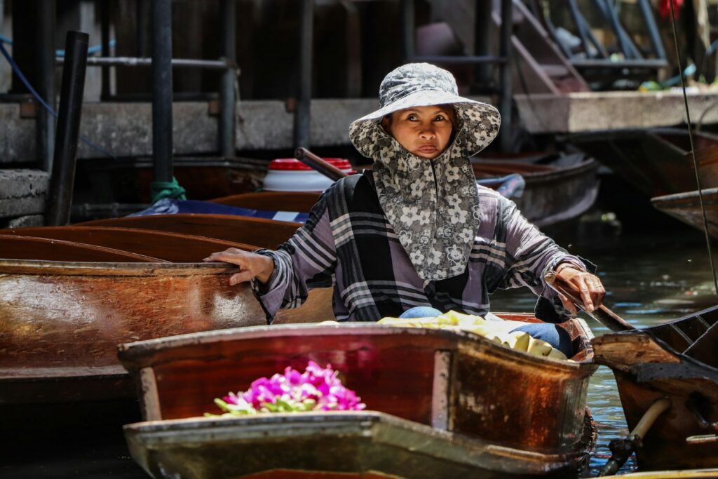 A woman sitting in a boat on a body of water
