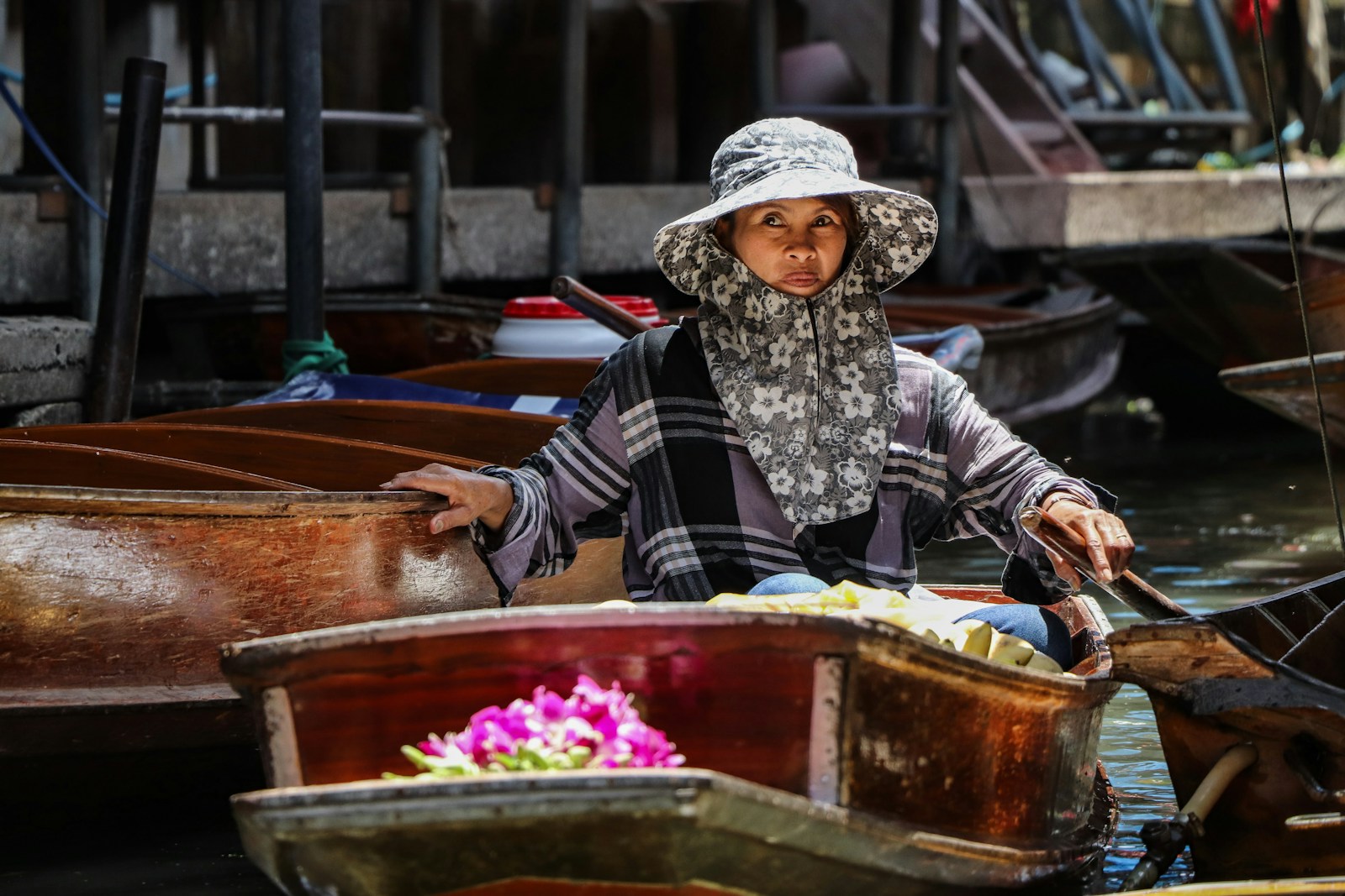 A woman sitting in a boat on a body of water