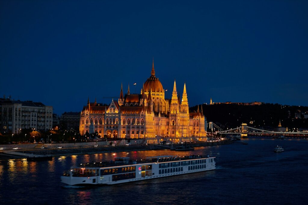 a boat on the water in front of a large building